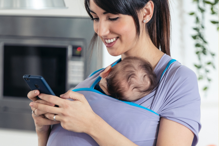 mom holding baby on phone