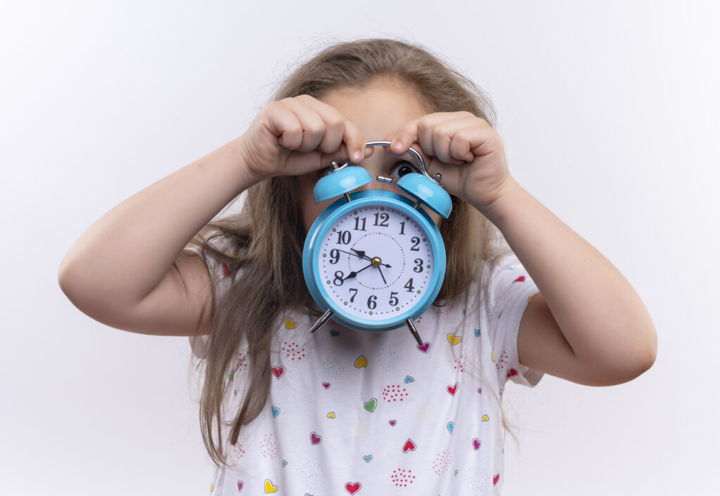 child holding clock